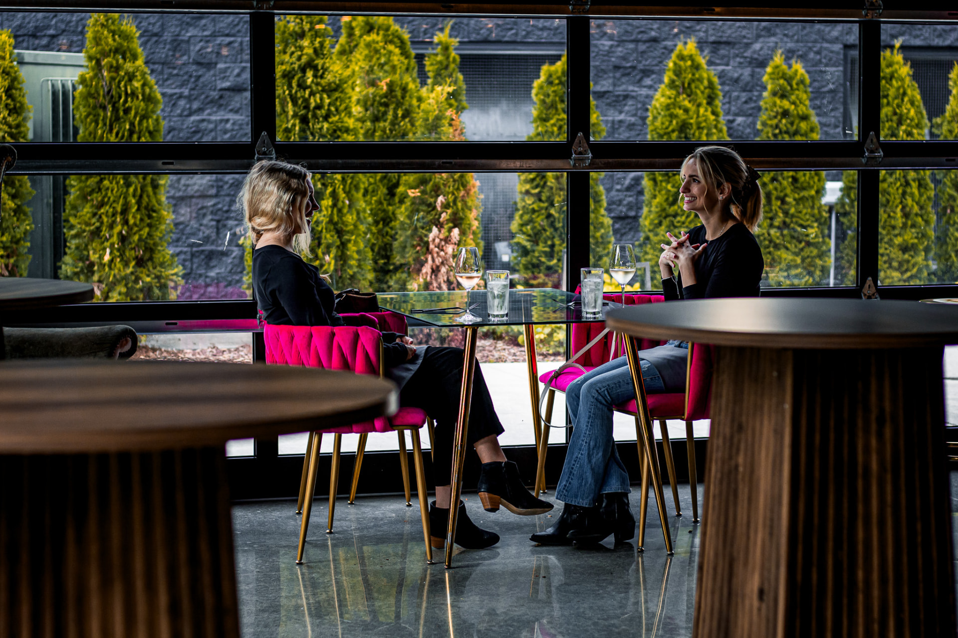 Guests in pink velvet chairs at Bottega